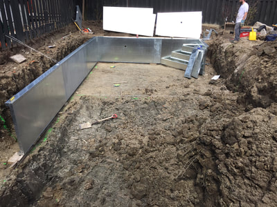 Steel walls being installed accurately for vinyl pool construction